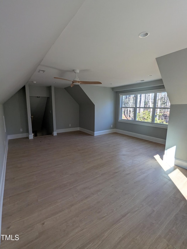 bonus room with ceiling fan, light hardwood / wood-style floors, and vaulted ceiling