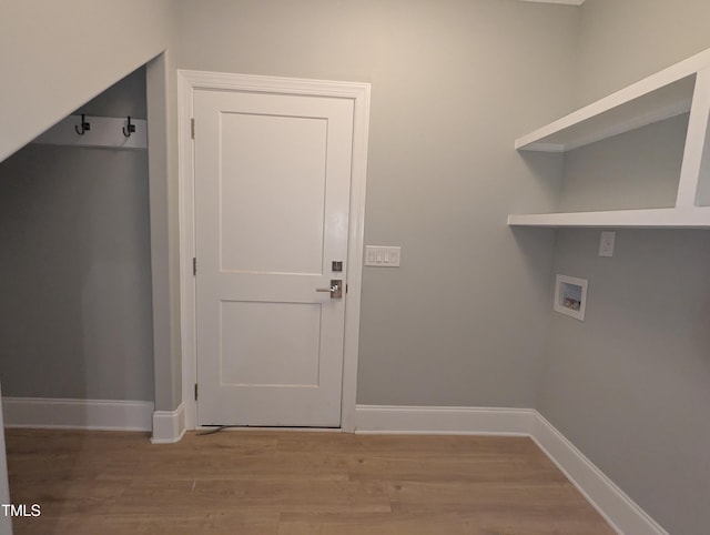 laundry area with light wood-type flooring and hookup for a washing machine