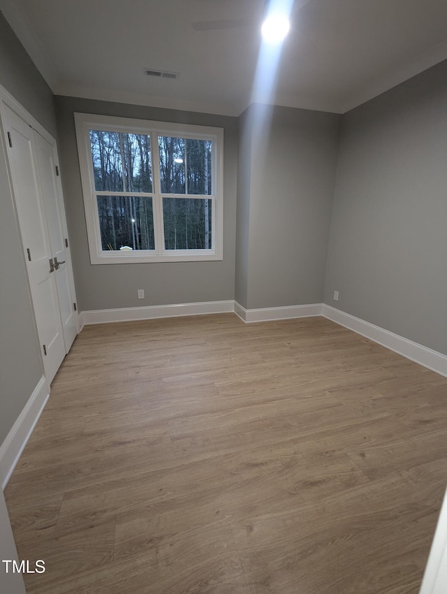 spare room featuring light wood-type flooring