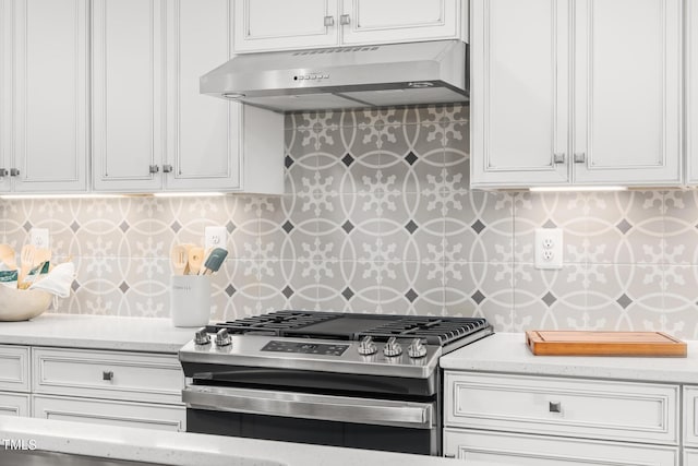 kitchen featuring white cabinets, range hood, and stainless steel range with gas stovetop