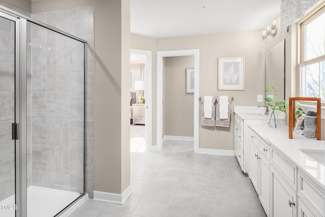 bathroom featuring tile patterned floors, vanity, and an enclosed shower