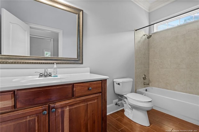 full bathroom featuring crown molding, wood-type flooring, toilet, vanity, and tiled shower / bath