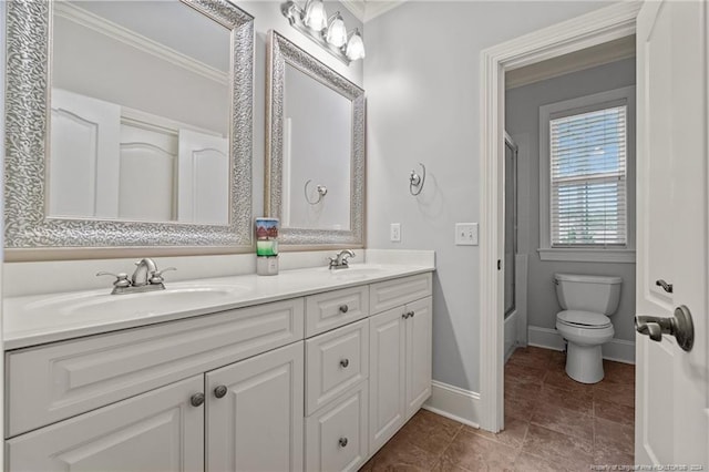 full bathroom featuring crown molding, vanity, enclosed tub / shower combo, and toilet