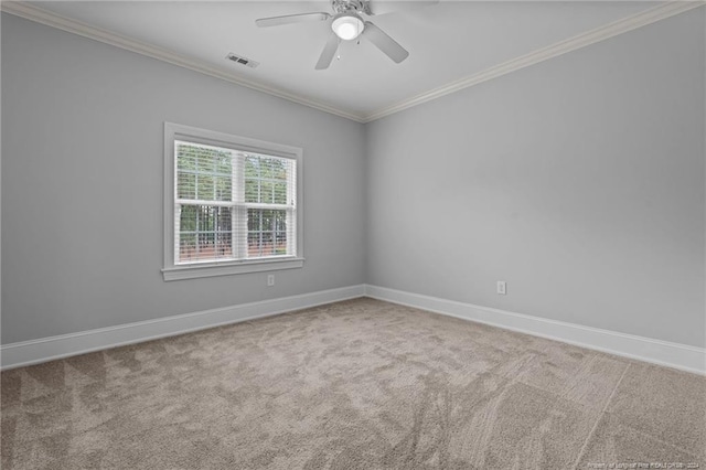 carpeted spare room with ceiling fan and ornamental molding