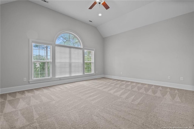 empty room featuring ceiling fan, high vaulted ceiling, and light colored carpet