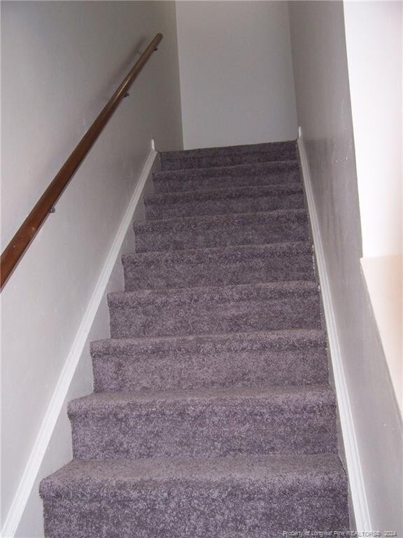 583 Winding Creek Rd Unit H, Fayetteville, NC 28305 - stairway featuring carpet