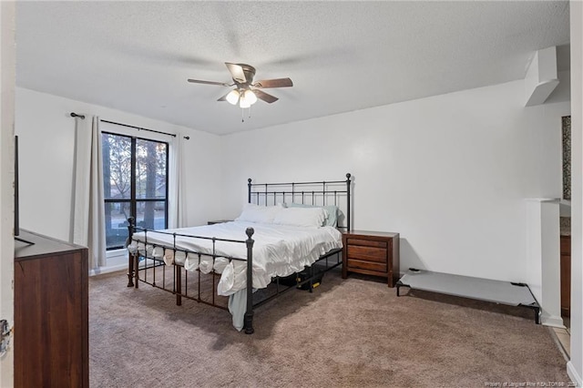 carpeted bedroom with ceiling fan and a textured ceiling