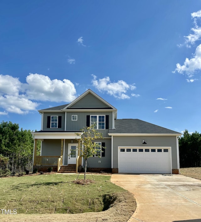 front of property featuring covered porch, a garage, and a front lawn