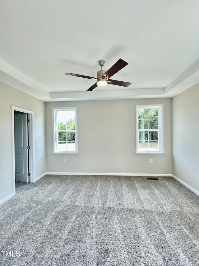 carpeted spare room with ceiling fan