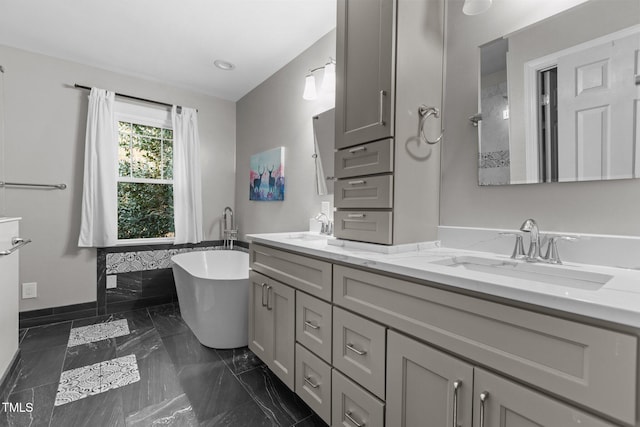 bathroom featuring a washtub and vanity