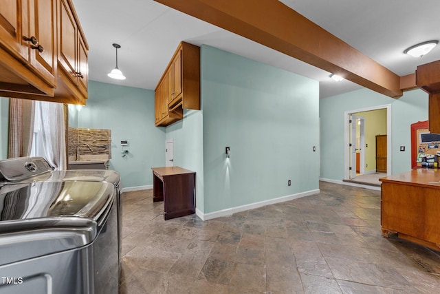 kitchen featuring separate washer and dryer and pendant lighting