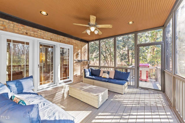 sunroom featuring a healthy amount of sunlight and ceiling fan