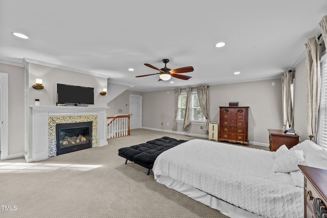 bedroom featuring a tile fireplace, light carpet, ceiling fan, and crown molding