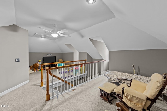 living area featuring ceiling fan, vaulted ceiling, and carpet flooring