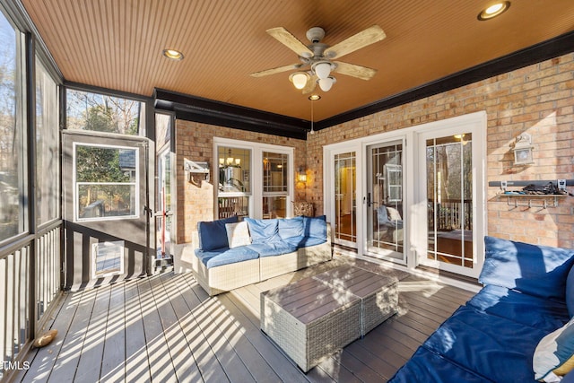 sunroom featuring ceiling fan