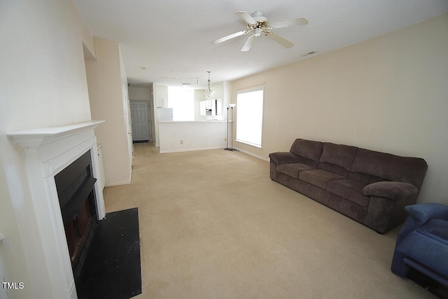 carpeted living room featuring ceiling fan