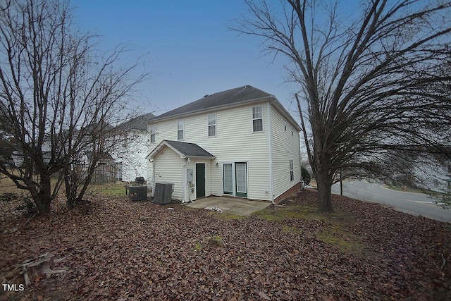 rear view of property featuring central AC unit and a patio area