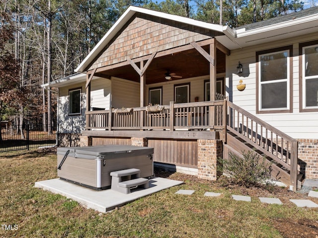 exterior space with a hot tub and ceiling fan