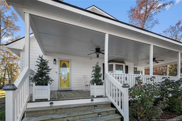 entrance to property with ceiling fan and a porch