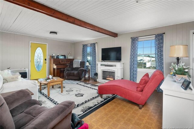 living room featuring beam ceiling and light hardwood / wood-style floors