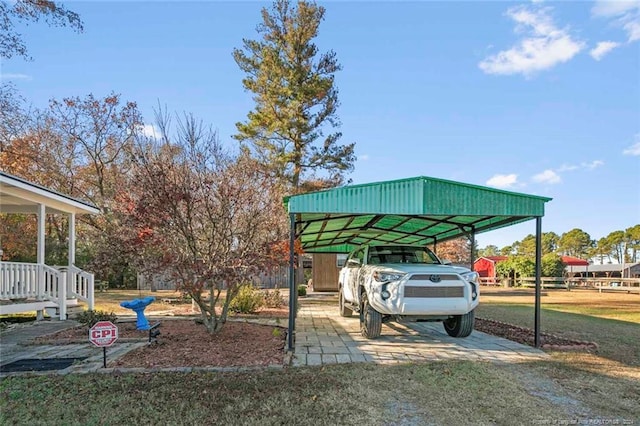 view of vehicle parking featuring a lawn and a carport