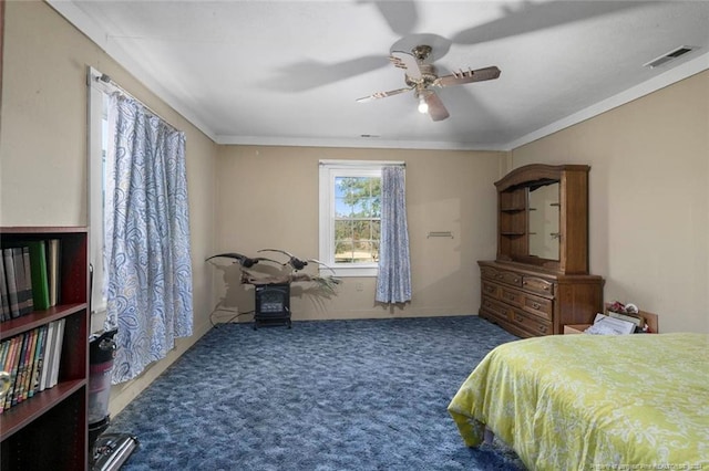 carpeted bedroom with ceiling fan and crown molding