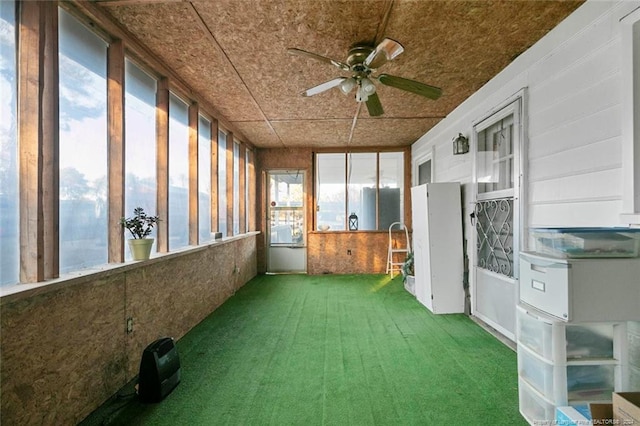 unfurnished sunroom with ceiling fan