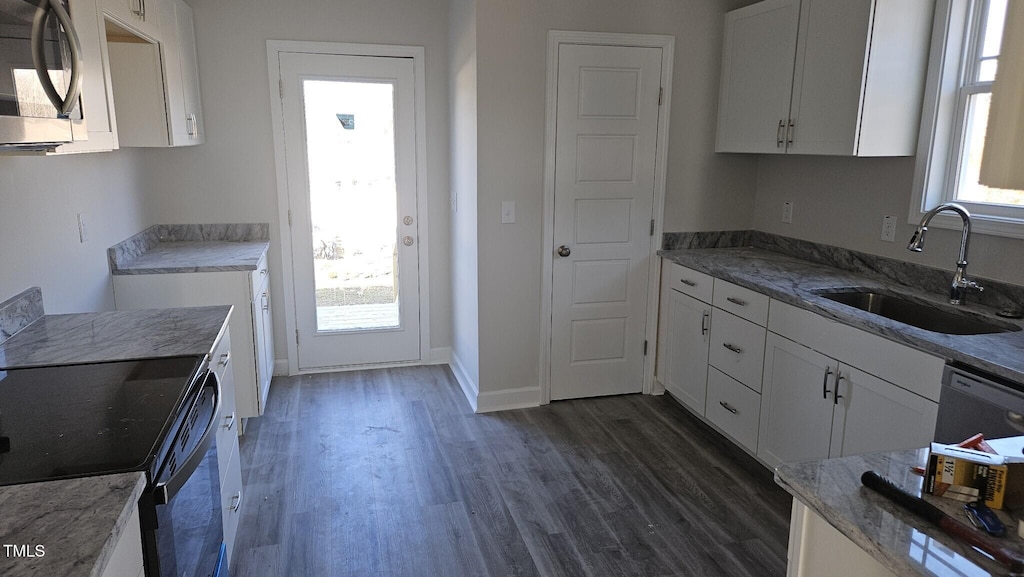 kitchen featuring range with electric cooktop, white dishwasher, sink, white cabinets, and dark hardwood / wood-style floors