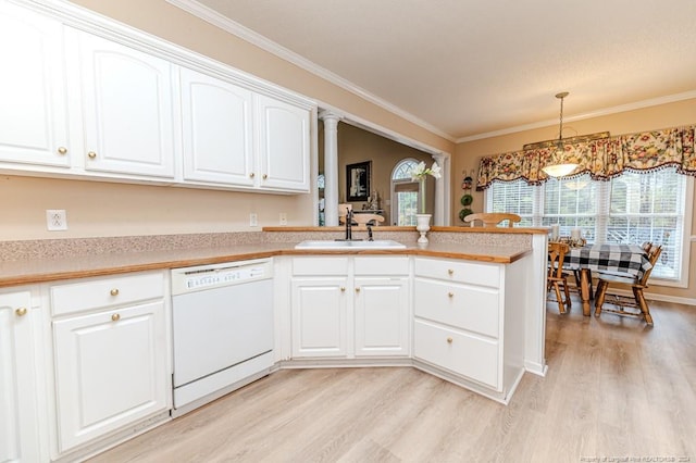 kitchen with white dishwasher, crown molding, sink, decorative light fixtures, and white cabinets