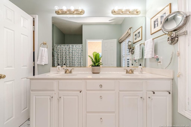 bathroom with a shower with shower curtain and vanity