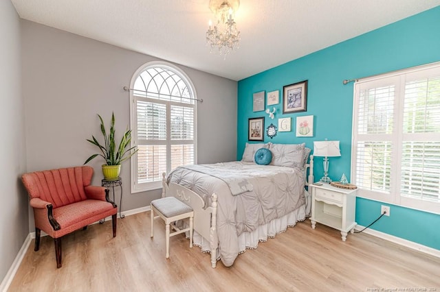 bedroom featuring a chandelier and wood-type flooring