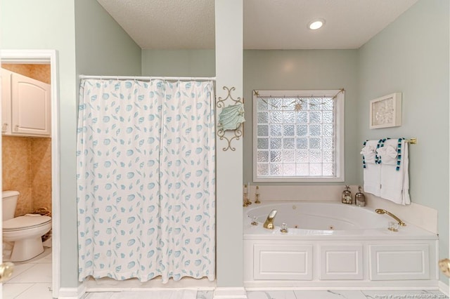 bathroom with tile patterned flooring, a textured ceiling, toilet, and a bathtub