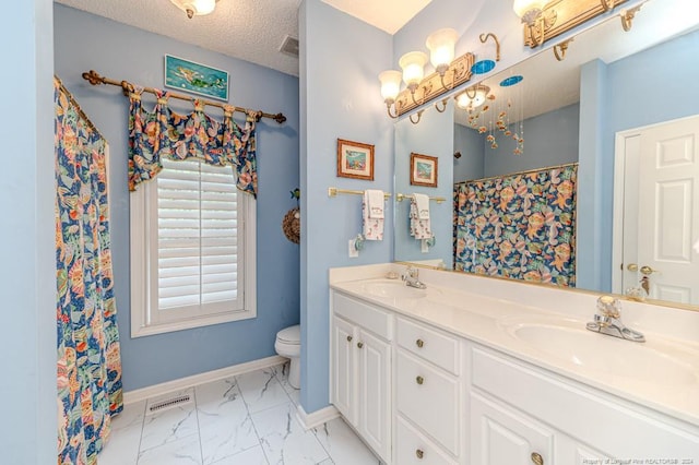 bathroom featuring walk in shower, vanity, a textured ceiling, and toilet