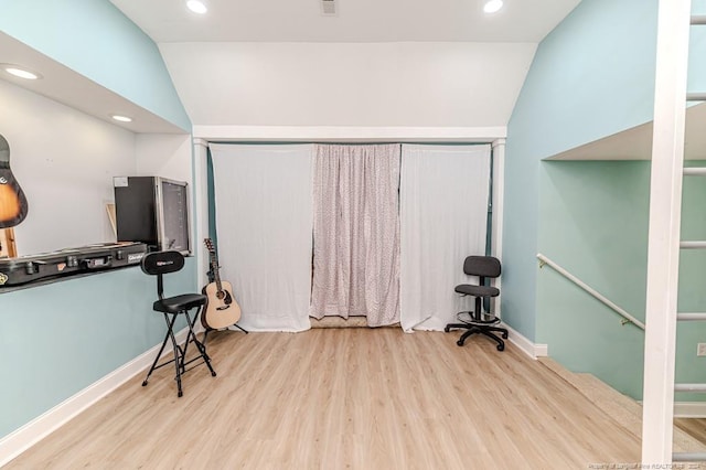 misc room with light wood-type flooring and lofted ceiling