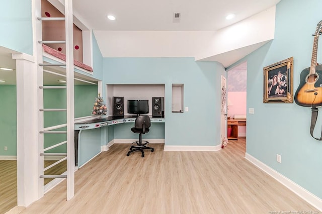 office area featuring built in desk and light hardwood / wood-style flooring