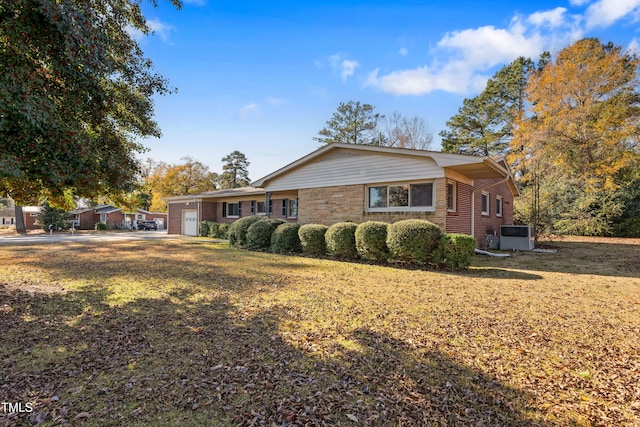 view of home's exterior featuring central AC and a yard