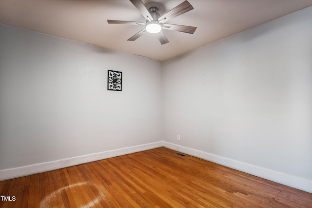 empty room with hardwood / wood-style flooring and ceiling fan