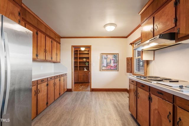 kitchen with light hardwood / wood-style flooring, stainless steel refrigerator, and ornamental molding