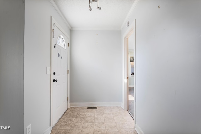 doorway featuring light tile patterned floors, a textured ceiling, and crown molding