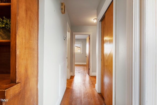 hallway with light hardwood / wood-style flooring