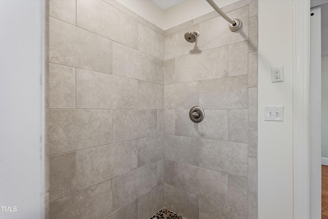 interior space with tiled shower and hardwood / wood-style flooring