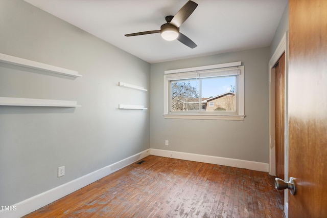 spare room with ceiling fan and hardwood / wood-style flooring