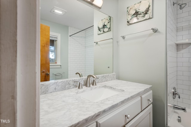 bathroom with vanity and tiled shower / bath