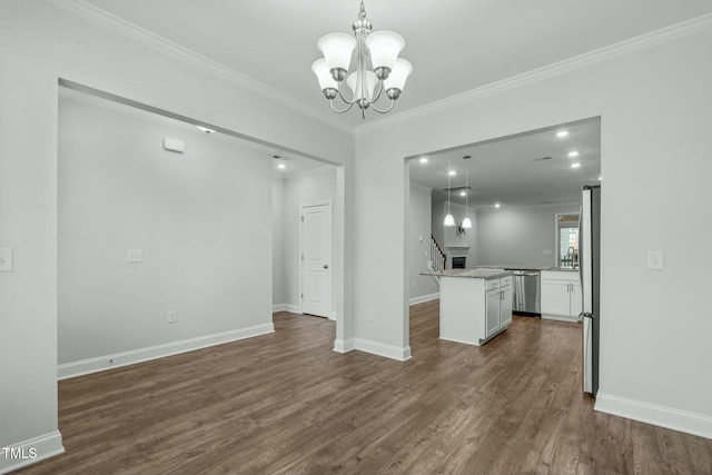 interior space featuring dark wood-type flooring, white cabinetry, hanging light fixtures, and a kitchen island