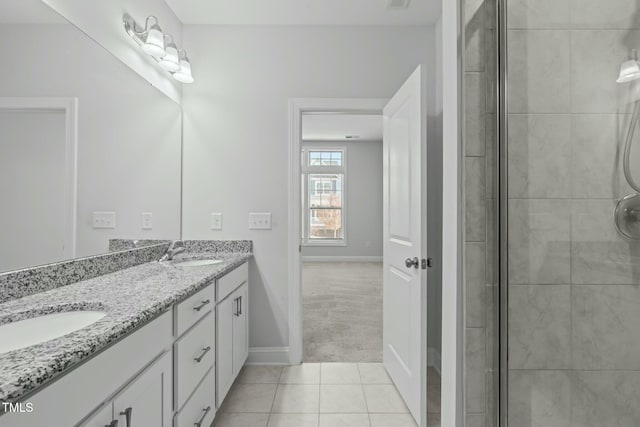 bathroom with tile patterned flooring, vanity, and a shower with shower door