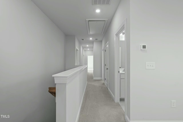 hallway with light colored carpet