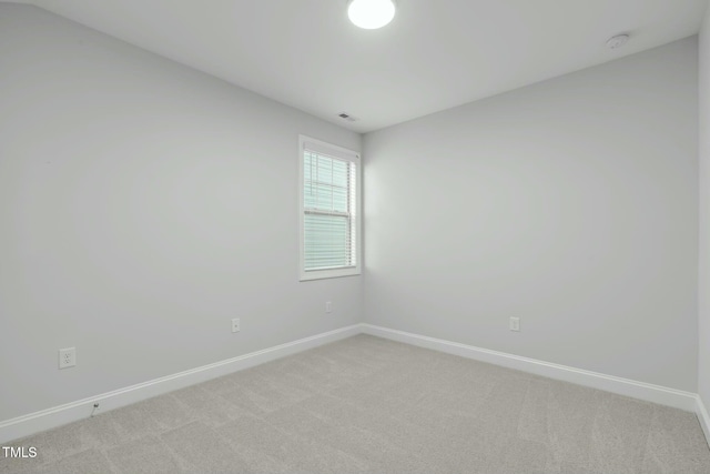 unfurnished room with light carpet