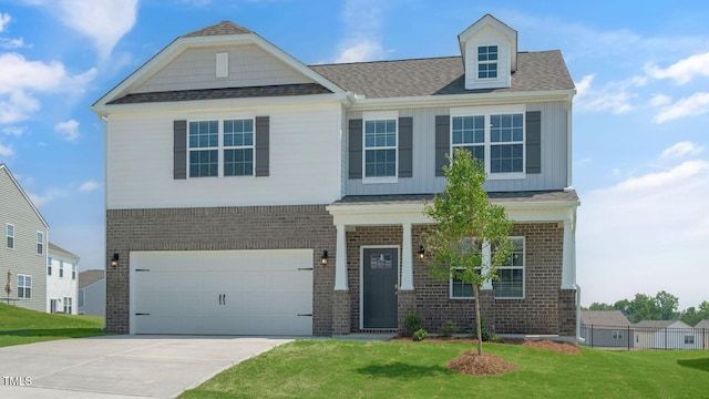273 Hanging Elm Ln, Fuquay Varina, NC 27526 - view of front of house with brick siding, an attached garage, a front lawn, driveway, and board and batten siding