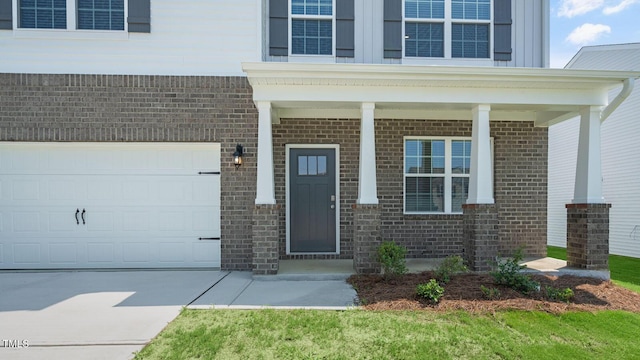 property entrance featuring a porch and a garage