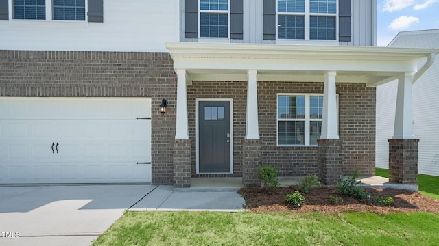 273 Hanging Elm Ln, Fuquay Varina, NC 27526 - property entrance with brick siding, a porch, and driveway